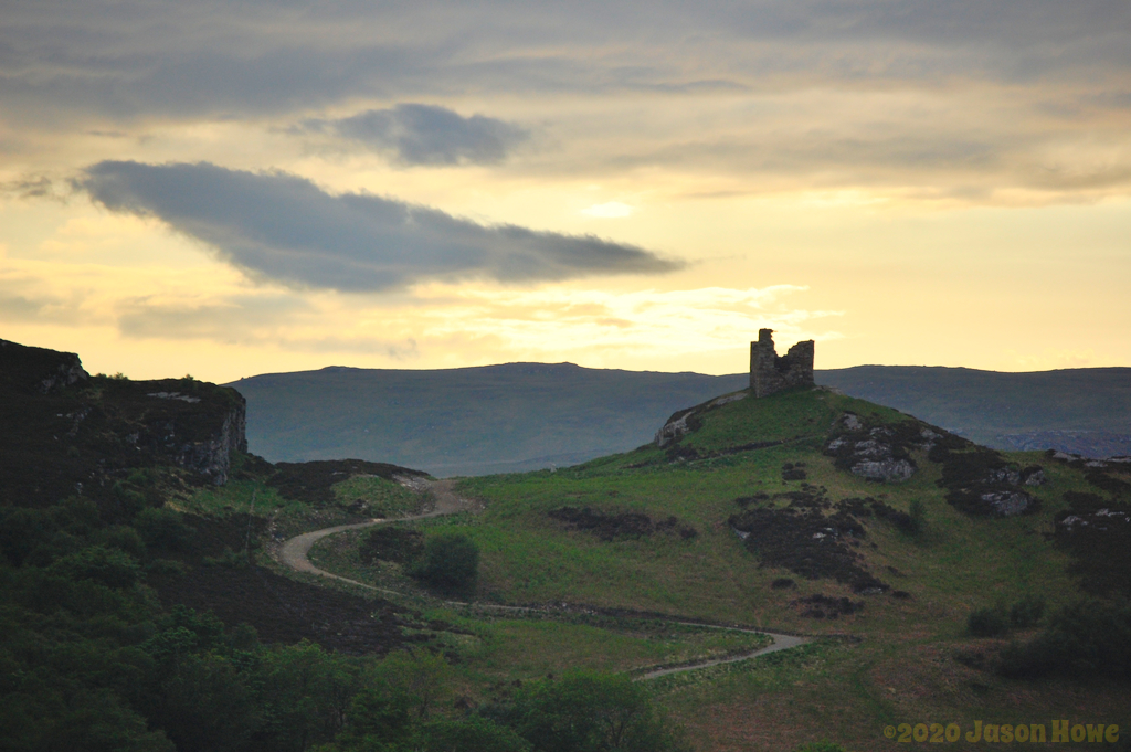 Castle ruin on top of a hill at sunset